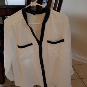 White top with faux leather trim.